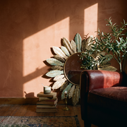 Bohemian Sunburst Metal Wall Mirror in a lived-in interior