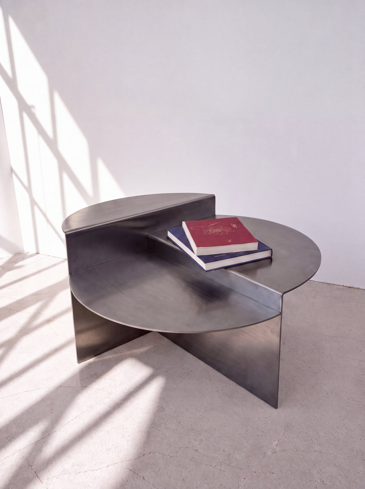 Sana Round Steel Coffee Table — round steel coffee table, in a darkened steel finish